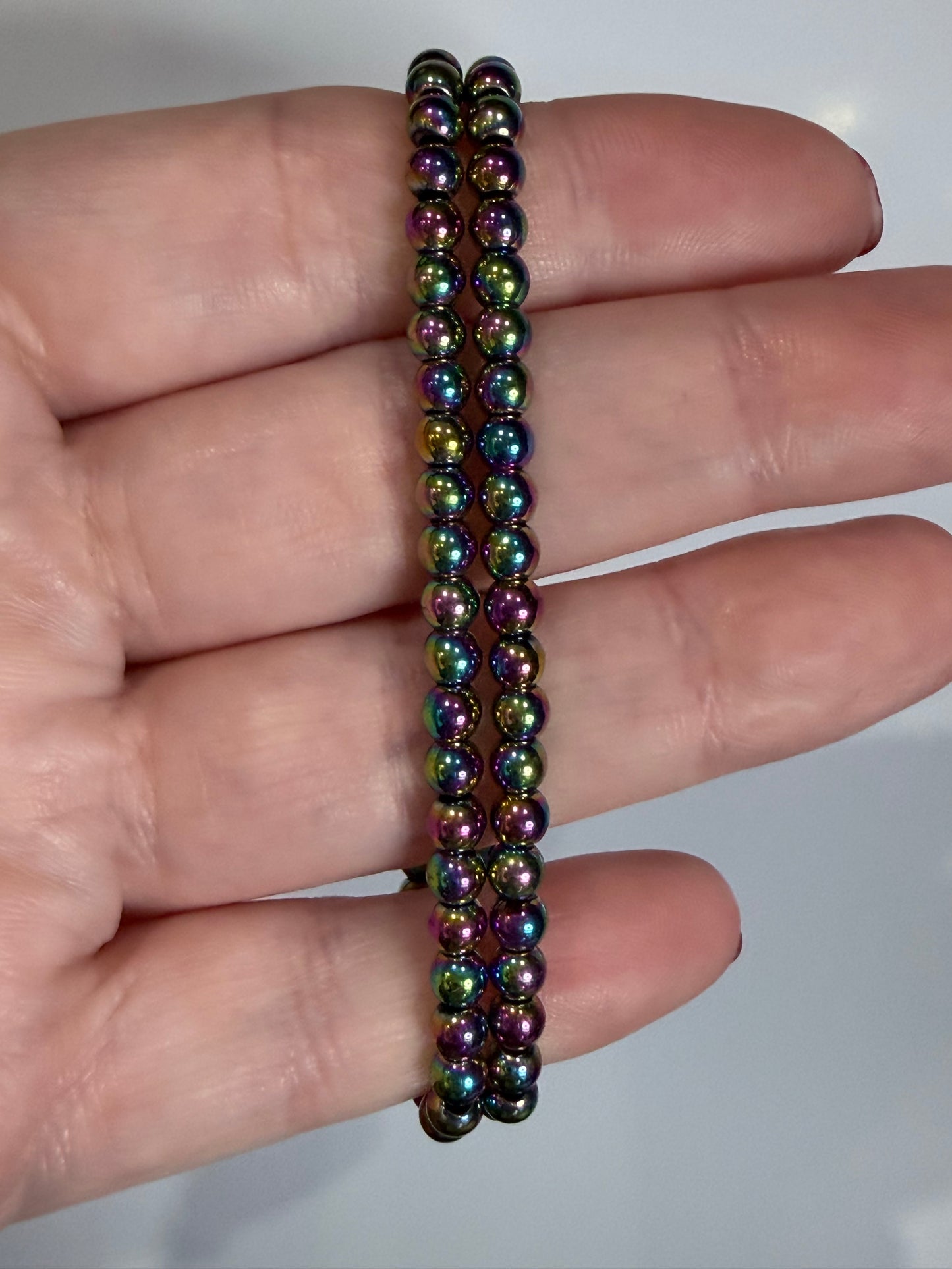 4 mm Aura Coated Hematite Bracelet –

Grounding • Balance • Protection